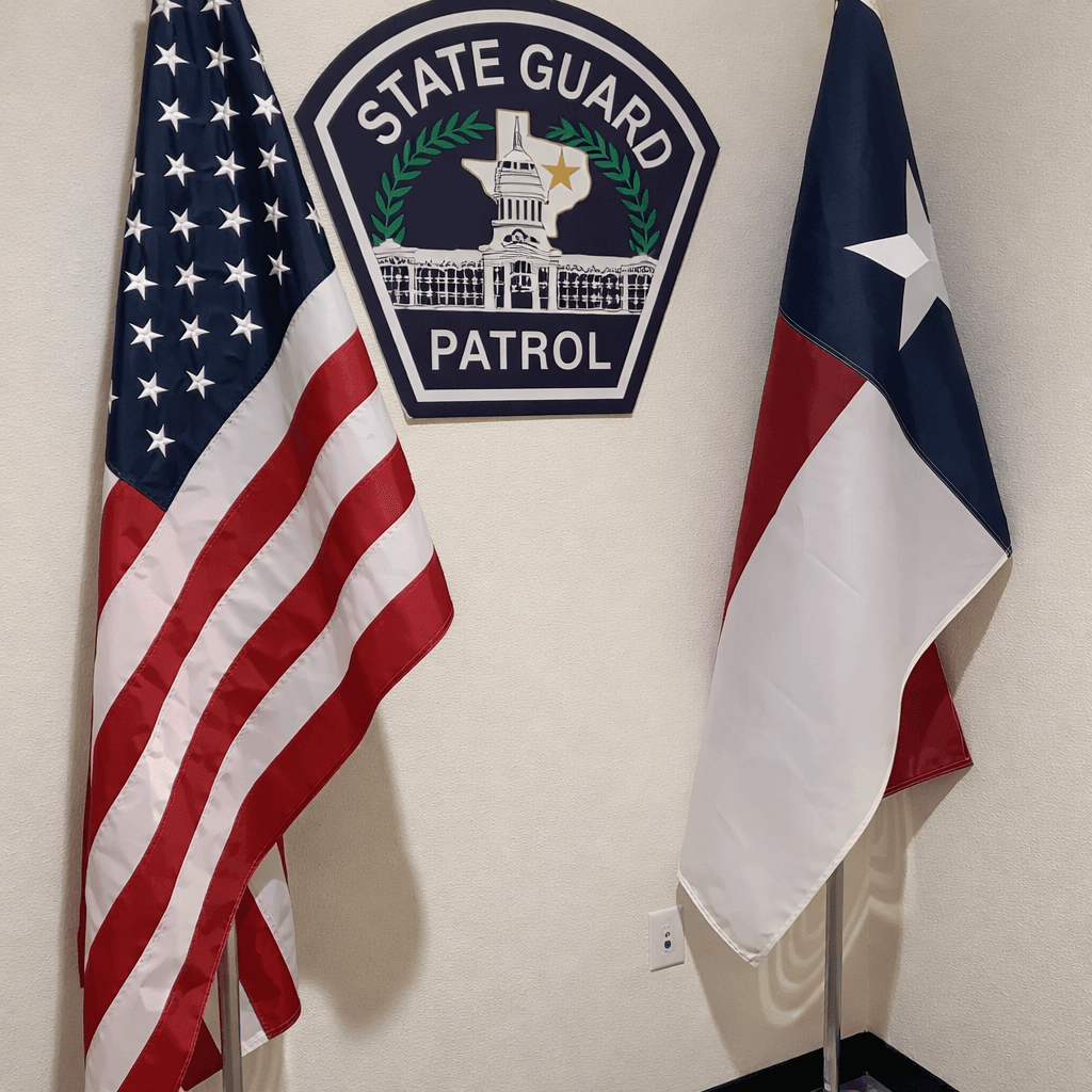 United States and Texas state flags representing State Guard Patrol commitment to serving Texas communities
